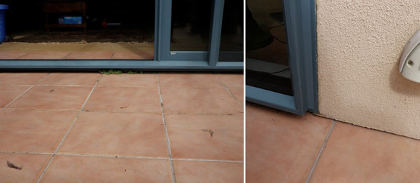 Photograph: Stucco plaster cladding and joinery close to a tiled deck.