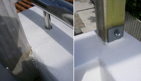 Photograph of top fixed stainless-steel and timber handrails penetrating an EIFS clad parapet with clear signs of water ingress around the penetration points.